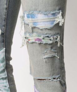 AMIRI PATCH-DETAIL DISTRESSED JEANS